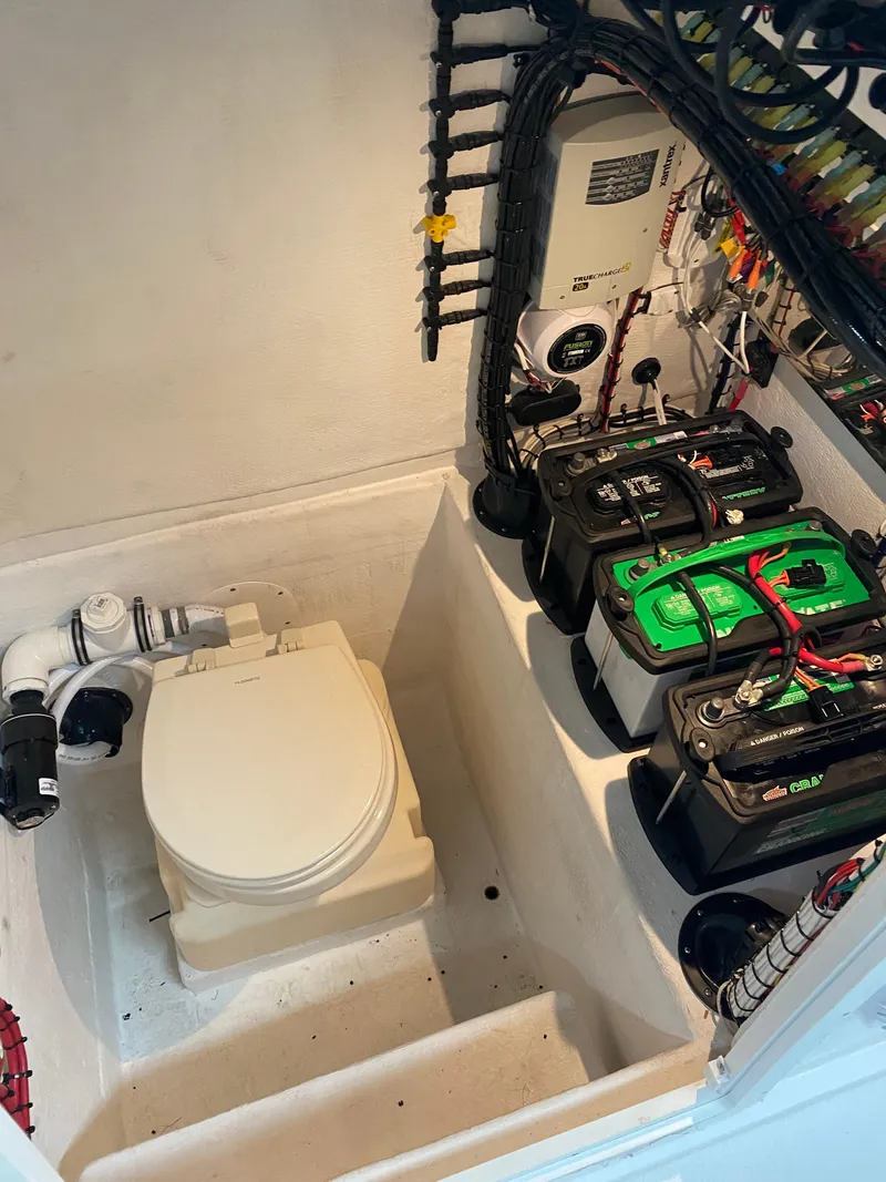 Slide: The Image of 2021 Ocean Runner 2900 CC boat interior with toilet and battery setup. - 23