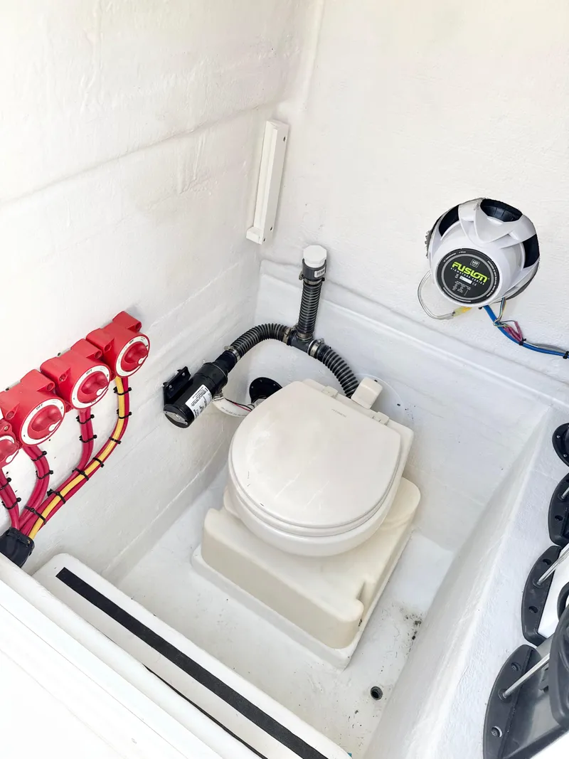 Slide: The Image of 2021 Ocean Runner 2900 CC boat interior with marine toilet and electrical components. - 24