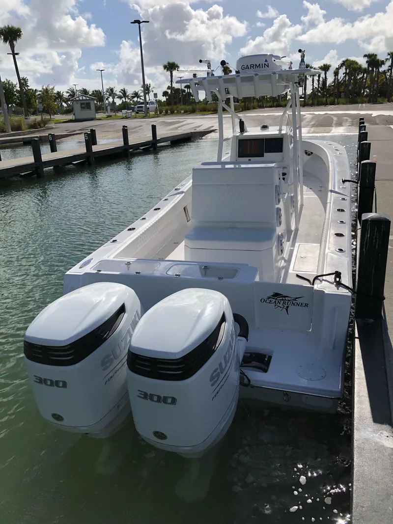 Slide: The Image of 2021 Ocean Runner 2900 CC boat docked with twin 300 horsepower engines. - 4