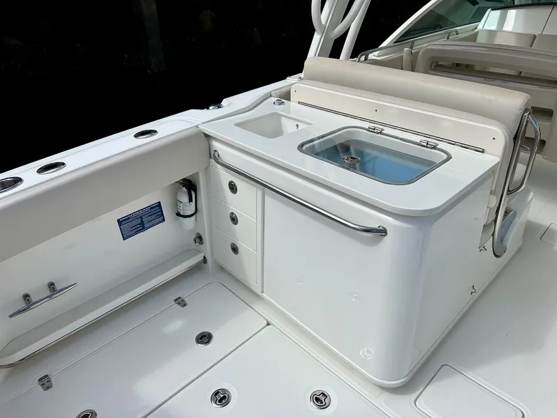 Slide: The Image of 2016 Boston Whaler 320 Vantage boat interior with sink and storage area. - 11