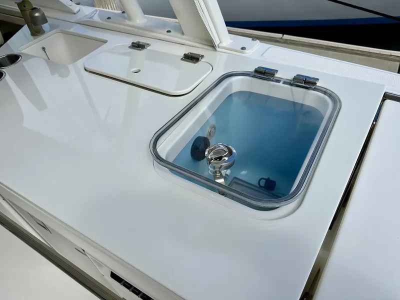 Slide: The Image of Boston Whaler 320 Vantage 2016 boat deck with sink and storage compartments. - 13