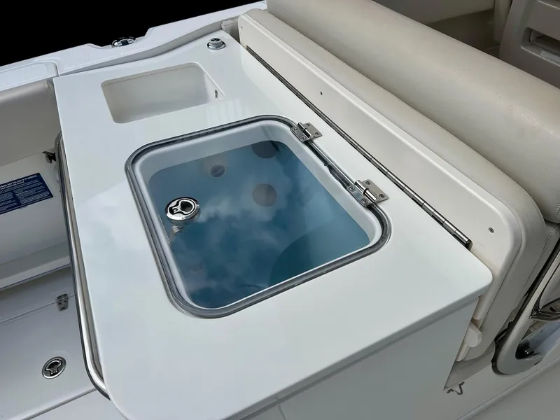 Slide: The Image of 2016 Boston Whaler 320 Vantage boat interior with livewell and seating area. - 14