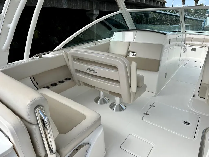 Slide: The Image of 2016 Boston Whaler 320 Vantage boat interior with beige seating and sleek design. - 15