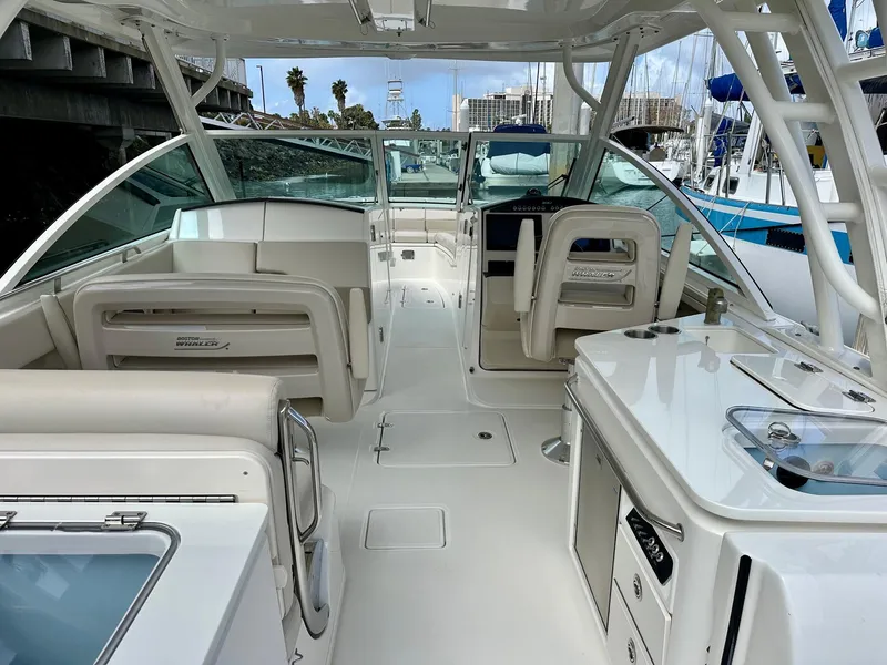 Slide: The Image of 2016 Boston Whaler 320 Vantage boat interior with seating and helm station. - 16