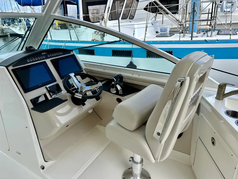 Slide: The Image of 2016 Boston Whaler 320 Vantage helm with dual screens and comfortable seating. - 17