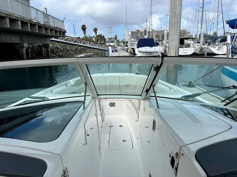Slide: The Image of 2016 Boston Whaler 320 Vantage boat docked in a marina with clear skies. - 18