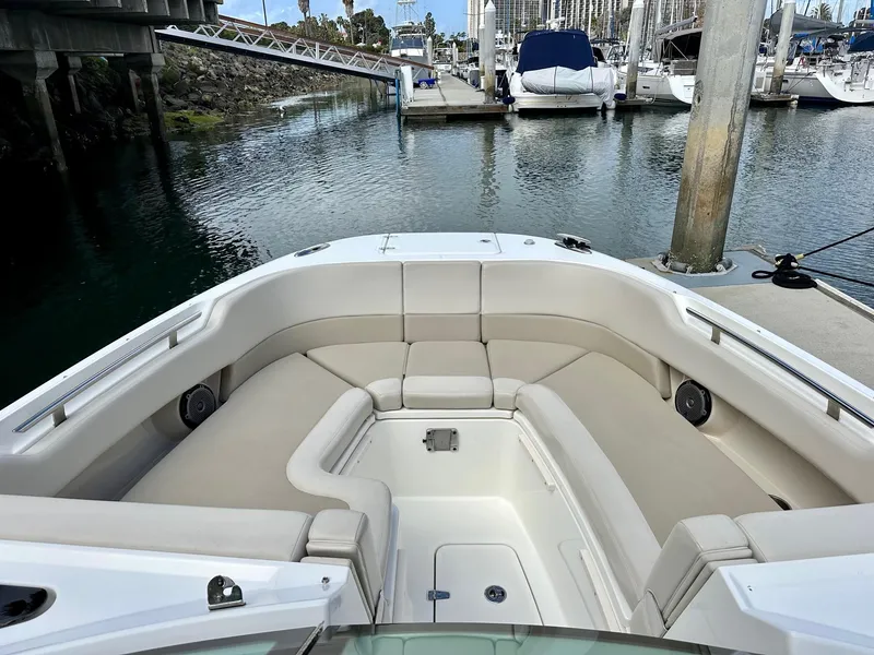 Slide: The Image of 2016 Boston Whaler 320 Vantage boat with spacious seating at a marina dock. - 19