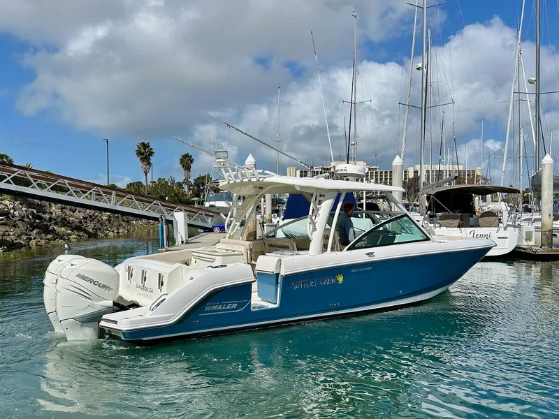 Slide: The Image of 2016 Boston Whaler 320 Vantage boat docked in a marina with clear blue water. - 5