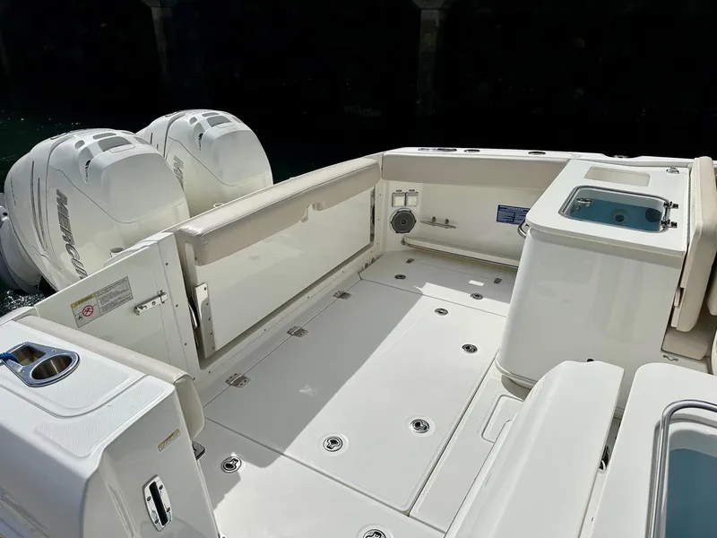 Slide: The Image of 2016 Boston Whaler 320 Vantage boat deck with dual engines and storage compartments. - 9