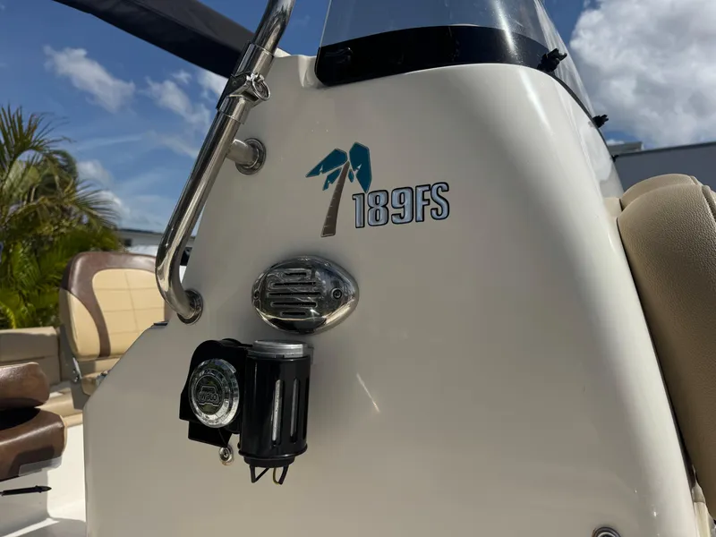 Slide: The Image of 2019 Key West 189 FS boat console with logo and equipment, under a clear blue sky. - 10