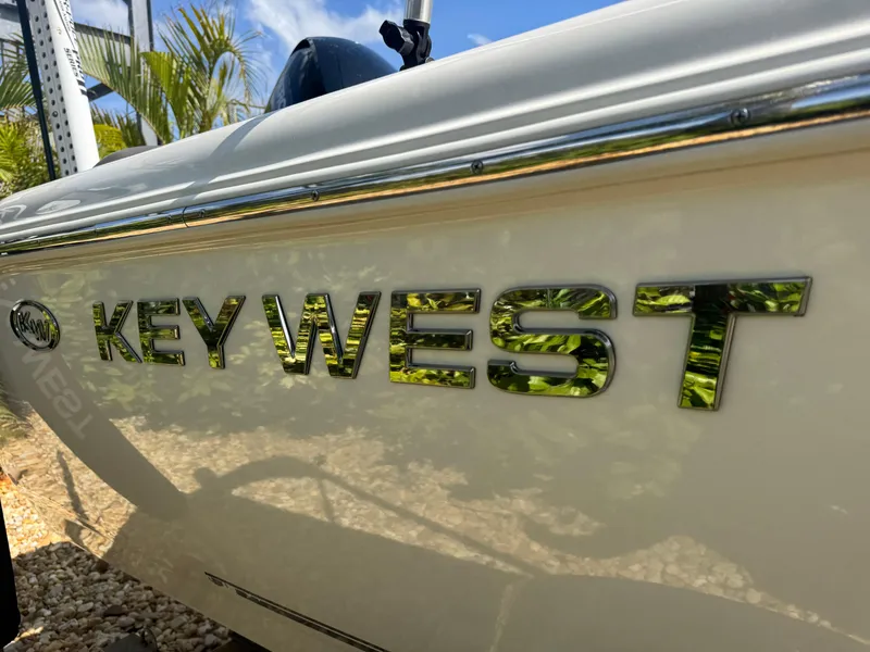 Slide: The Image of 2019 Key West 189 FS boat side view with logo and reflection. - 12
