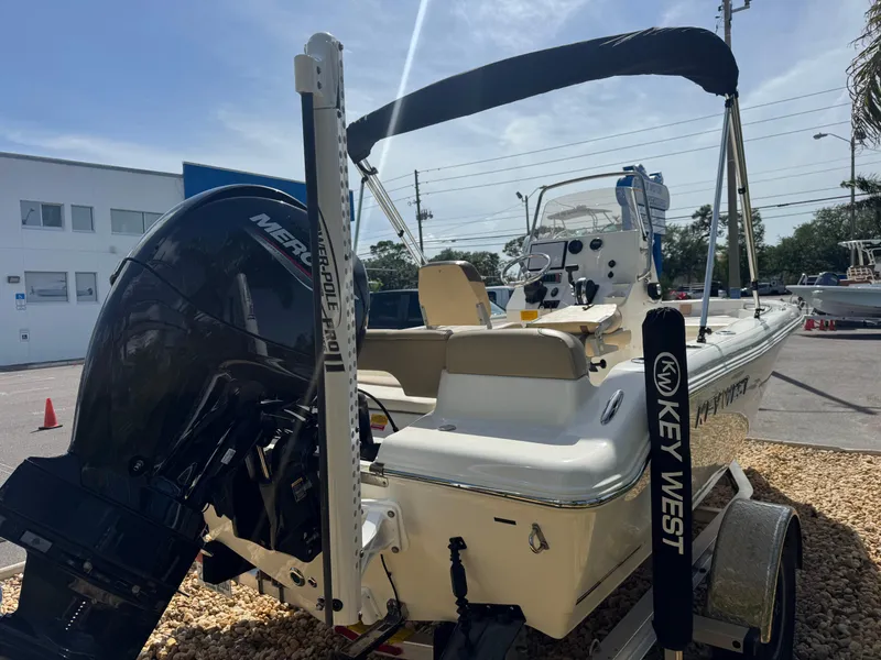 Slide: The Image of 2019 Key West 189 FS boat with Mercury engine, parked on gravel. - 14