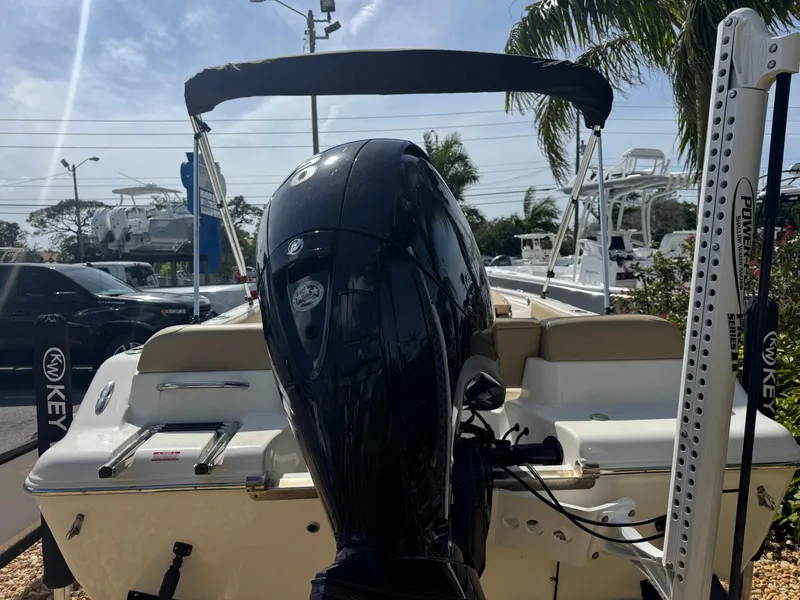 Slide: The Image of 2019 Key West 189 FS boat with outboard motor and canopy, parked outdoors. - 15
