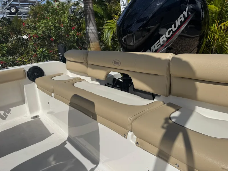 Slide: The Image of 2019 Key West 189 FS boat interior with beige seating and Mercury engine. - 20