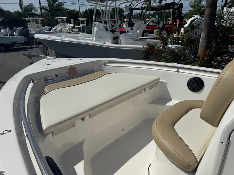 Slide: The Image of 2019 Key West 189 FS boat interior with seating and console, displayed outdoors. - 24