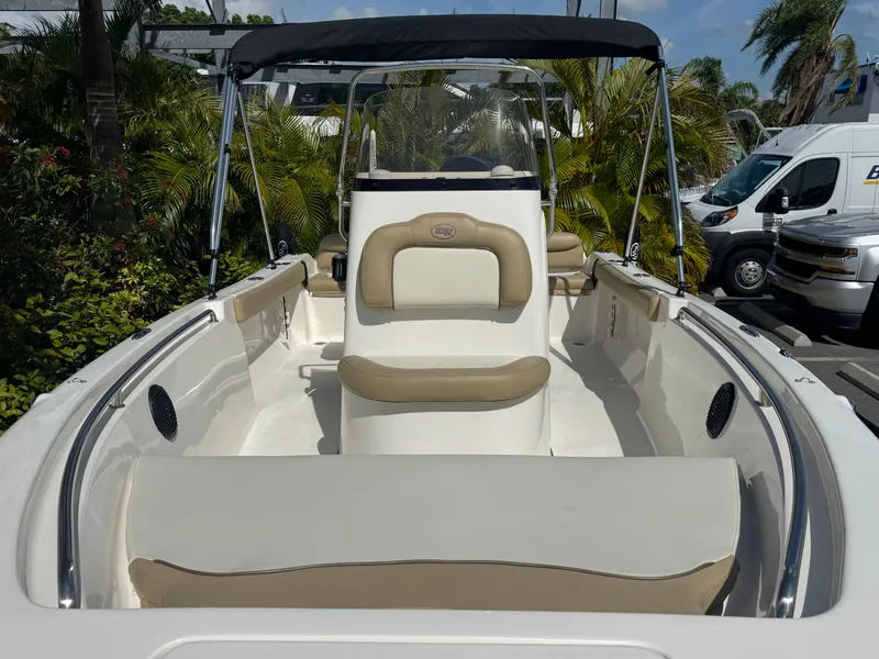 Slide: The Image of 2019 Key West 189 FS boat with seating, canopy, and lush background. - 28