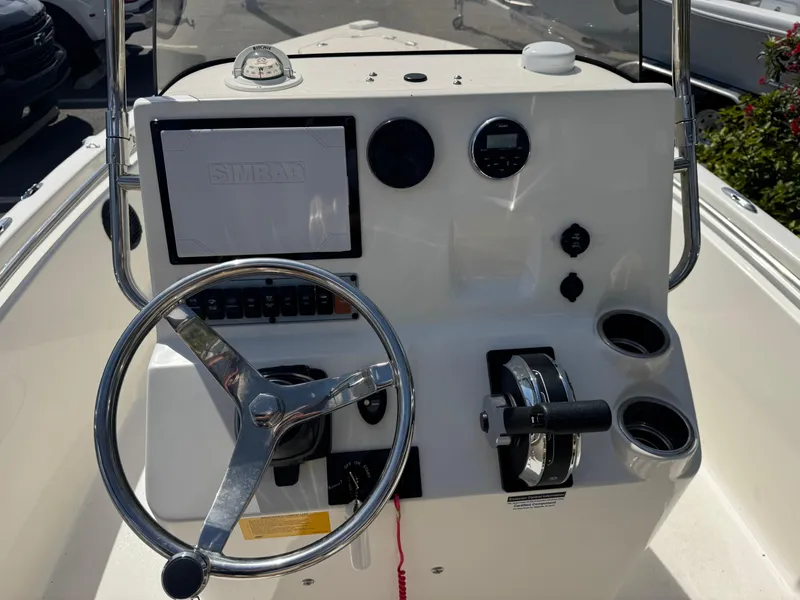 Slide: The Image of 2019 Key West 189 FS boat console with steering wheel and controls. - 29
