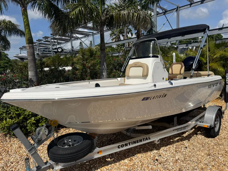 Slide: The Image of 2019 Key West 189 FS boat on trailer, surrounded by palm trees. - 3