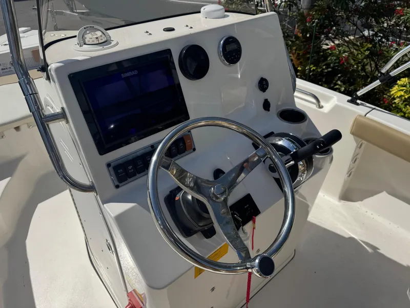 Slide: The Image of 2019 Key West 189 FS boat console with steering wheel and navigation display. - 30
