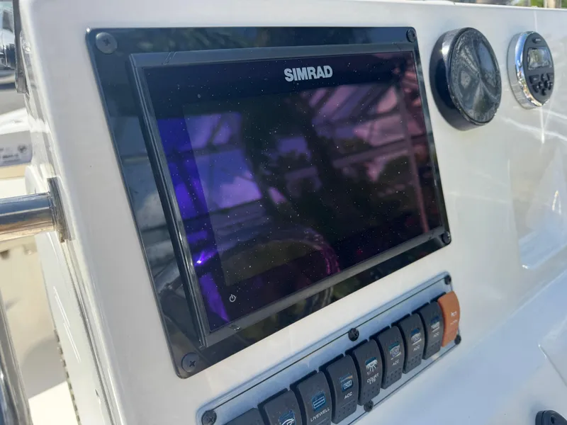 Slide: The Image of Control panel of 2019 Key West 189 FS boat with Simrad display and switches. - 31
