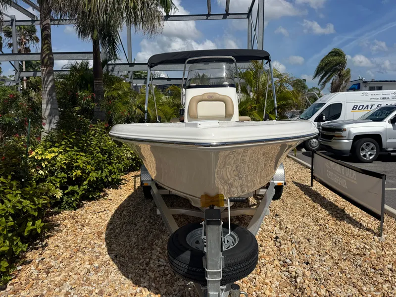 Slide: The Image of 2019 Key West 189 FS boat on trailer, surrounded by tropical plants. - 4
