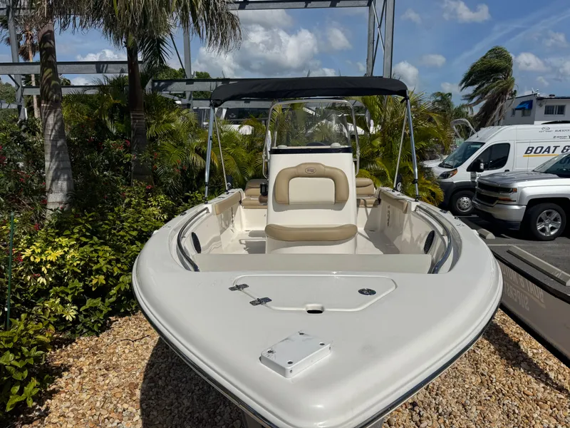 Slide: The Image of 2019 Key West 189 FS boat with canopy, parked outdoors amidst greenery. - 5