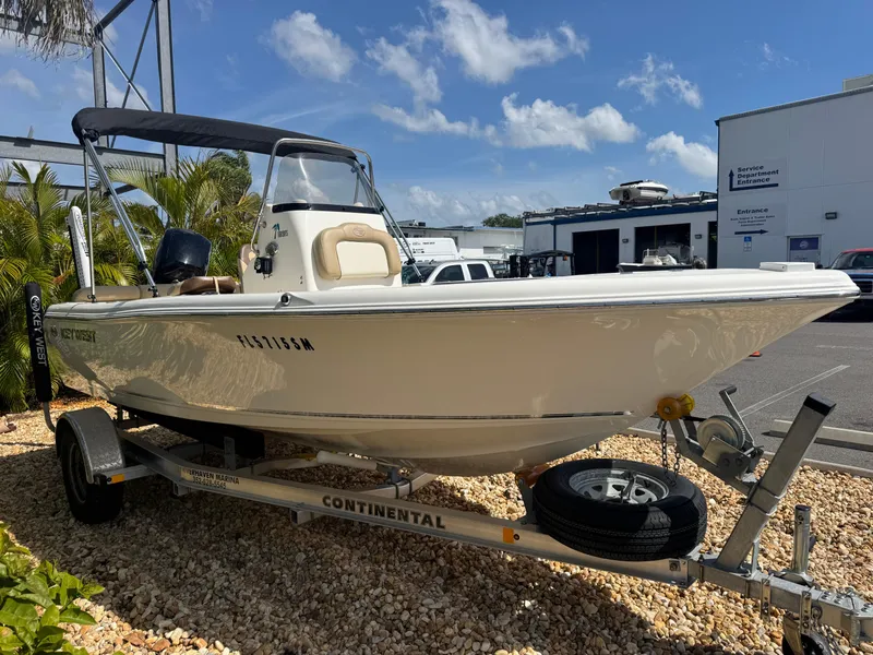 Slide: The Image of 2019 Key West 189 FS boat on trailer, parked outdoors under blue sky. - 6
