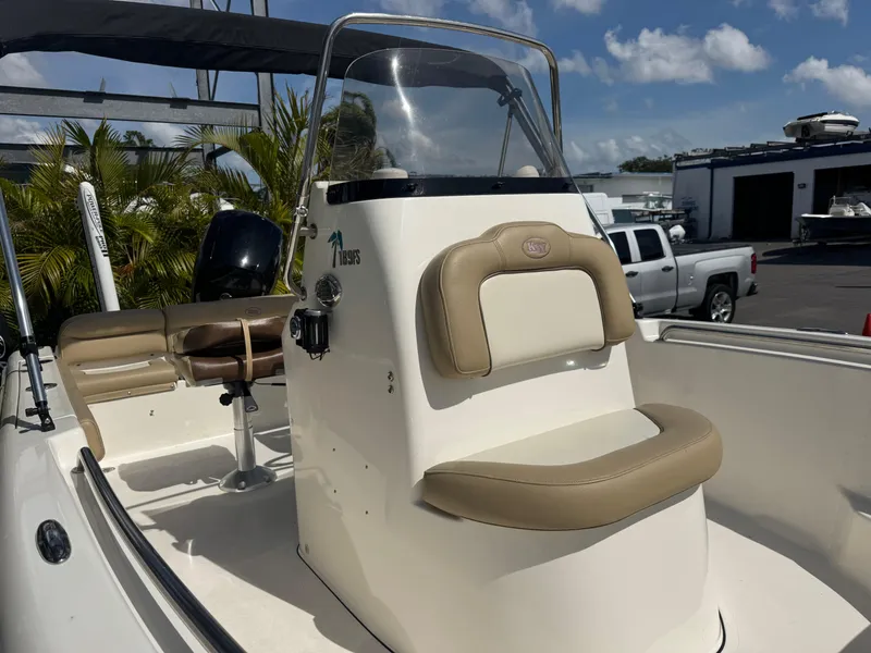 Slide: The Image of 2019 Key West 189 FS boat with beige seating and console, under a clear blue sky. - 9