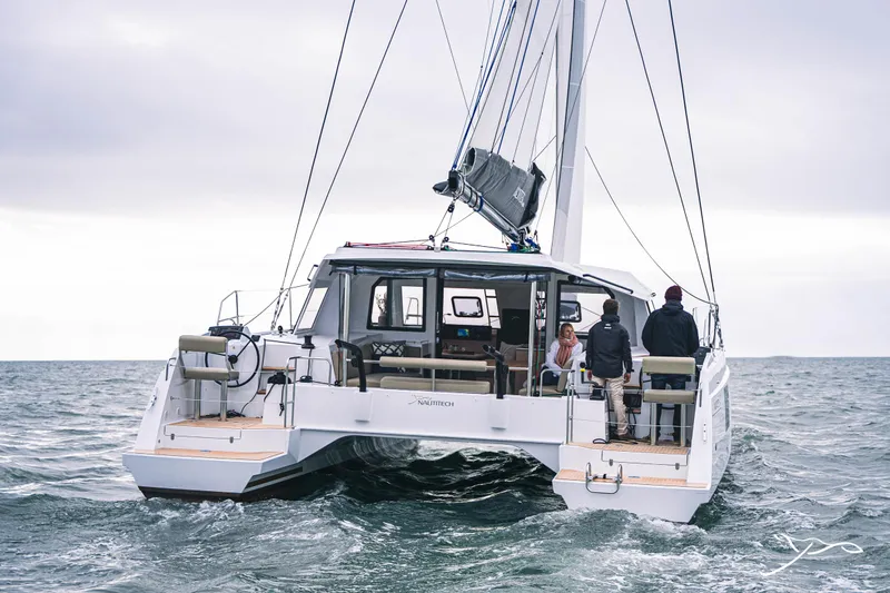 Slide: The Image of 2025 Nautitech 40 Open catamaran sailing on open sea, rear view. - 7