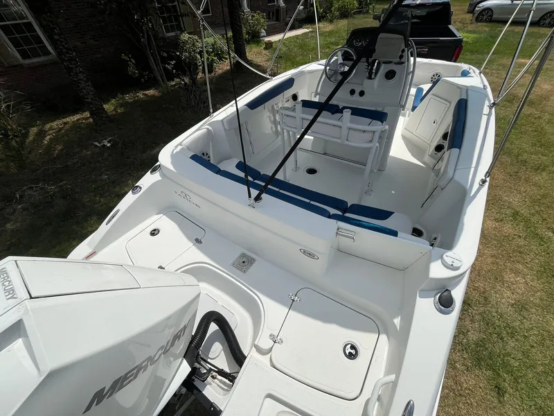 Slide: The Image of 2020 Tahoe 2150 CC boat interior with seating and Mercury engine. - 12