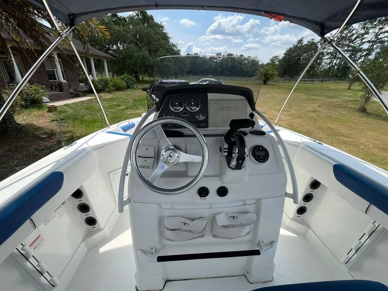Slide: The Image of 2020 Tahoe 2150 CC boat cockpit with steering wheel and control panel. - 16
