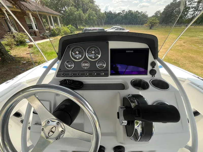 Slide: The Image of 2020 Tahoe 2150 CC boat dashboard with steering wheel and control panel. - 17