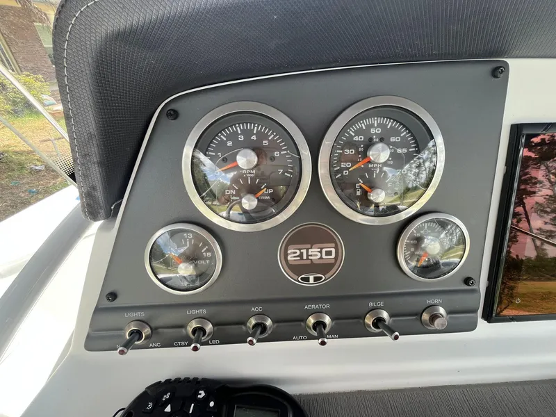 Slide: The Image of Dashboard of a 2020 Tahoe 2150 CC boat with gauges and controls. - 18