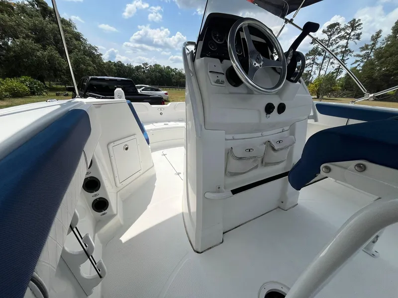 Slide: The Image of 2020 Tahoe 2150 CC boat interior with steering wheel and seating. - 21