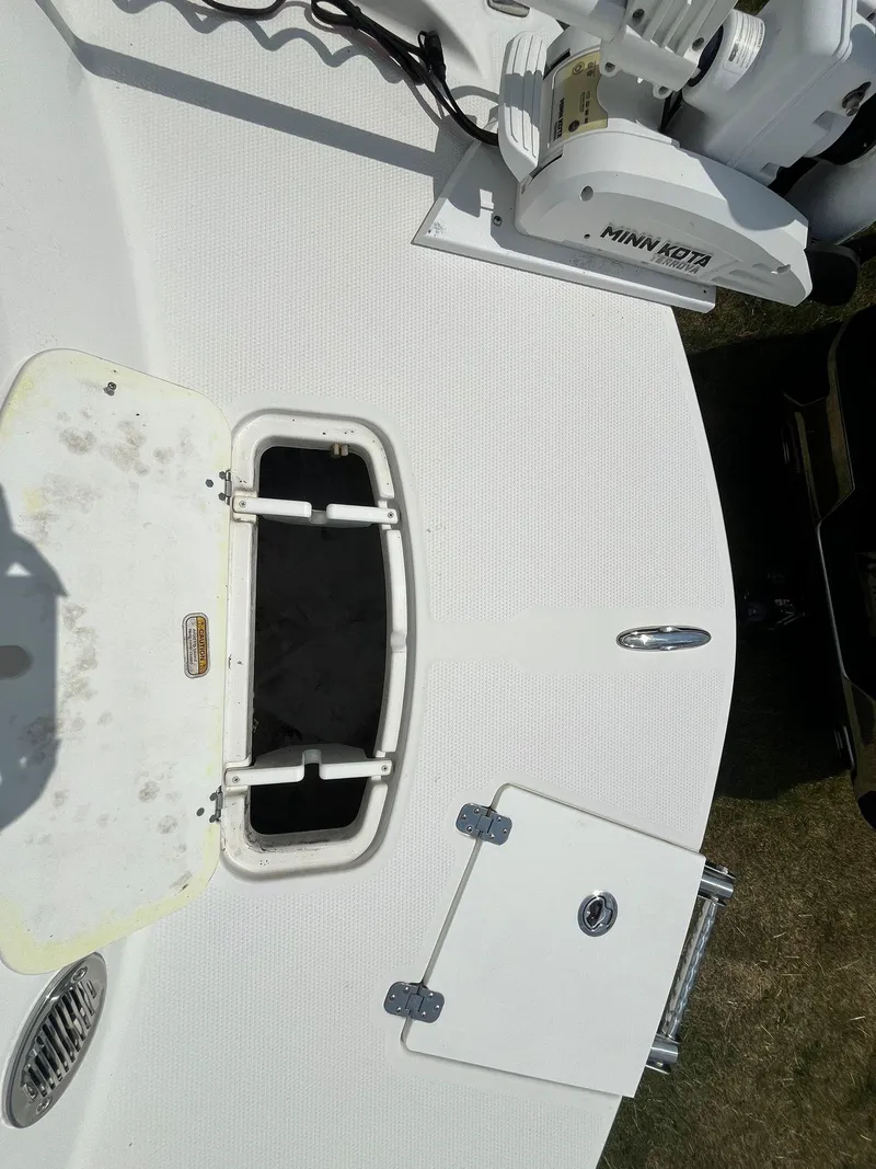 Slide: The Image of 2020 Tahoe 2150 CC boat deck with storage compartments and Minn Kota trolling motor. - 32