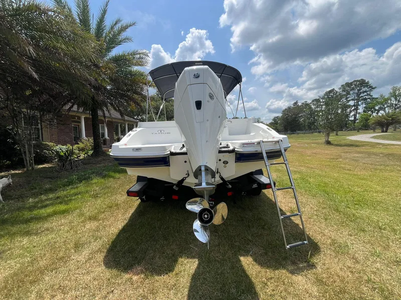 Slide: The Image of 2020 Tahoe 2150 CC boat on trailer, parked on grass under a partly cloudy sky. - 4