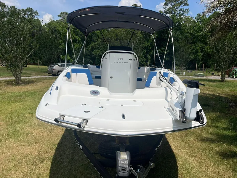 Slide: The Image of 2020 Tahoe 2150 CC boat with canopy, parked on grass, rear view. - 7