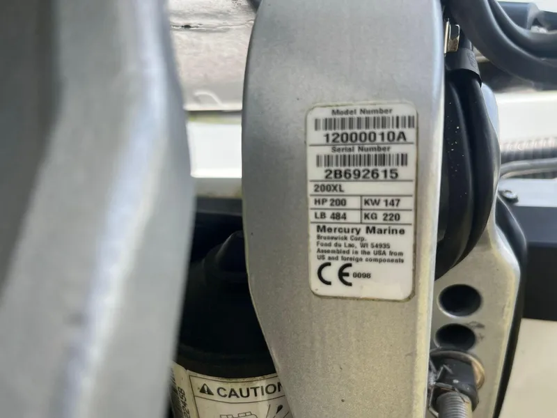 Slide: The Image of Label on Mercury Marine engine, model 200XL, showing specifications and serial number. - 9