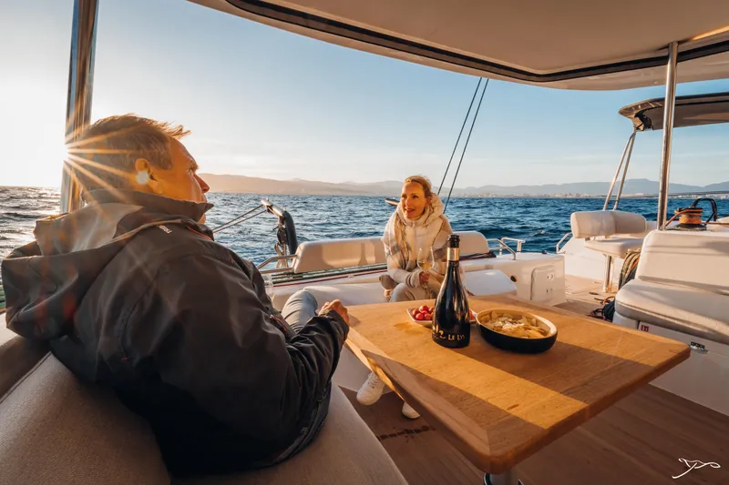 Slide: The Image of Couple enjoying sunset on Nautitech 44 Open yacht, 2025 model, with wine and snacks. - 25
