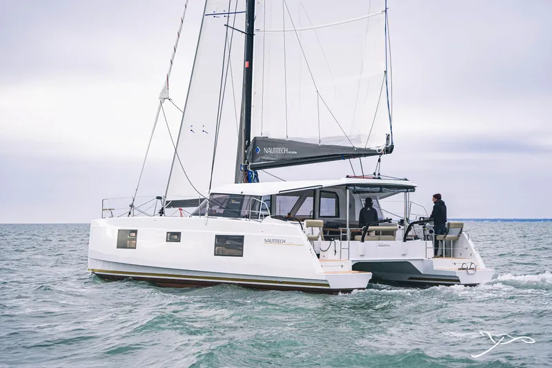 Slide: The Image of 2025 Nautitech 40 Open catamaran sailing on the ocean with two people onboard. - 4