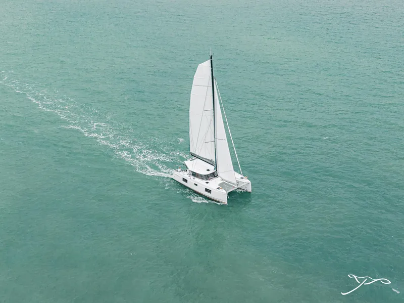 Slide: The Image of 2025 Nautitech 40 Open catamaran sailing on open sea, aerial view. - 7