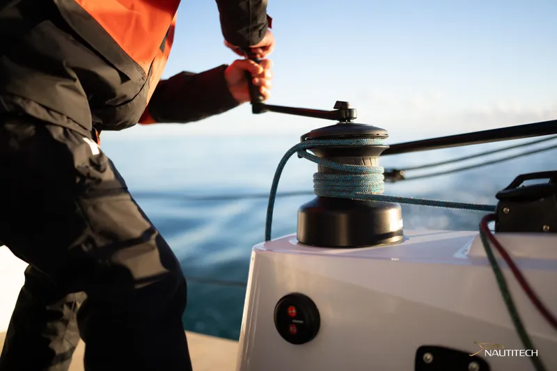 Slide: The Image of Person operating winch on Nautitech 48 Open catamaran, 2025 model, at sea. - 27