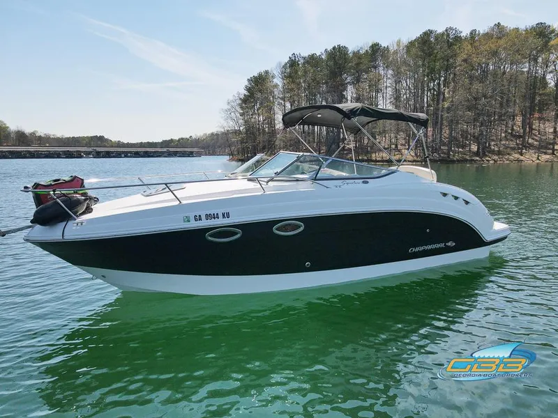 Slide: The Image of 2008 Chaparral Signature 250 boat on a lake with trees in the background. - 0