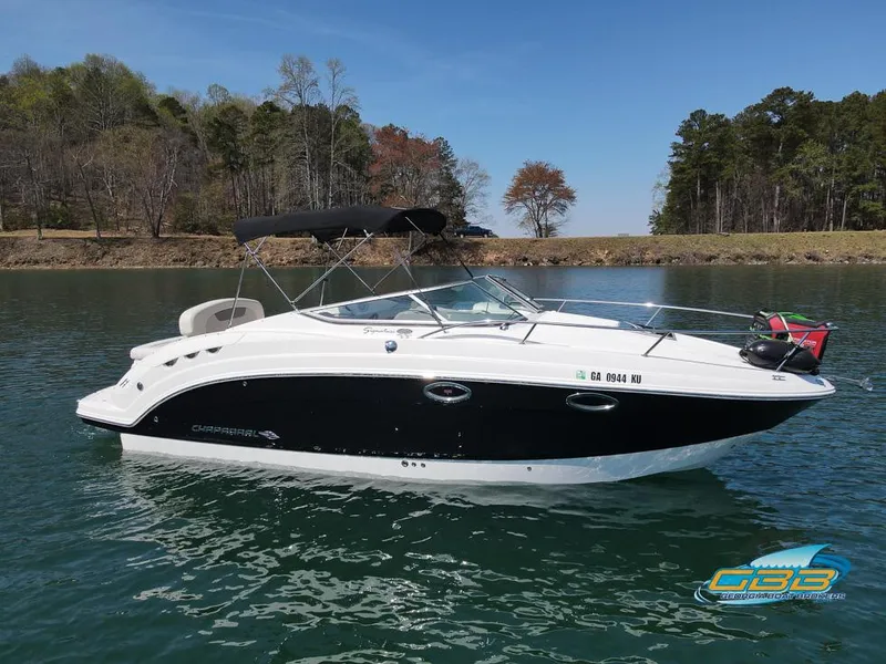 Slide: The Image of 2008 Chaparral Signature 250 boat on a serene lake with trees in the background. - 1