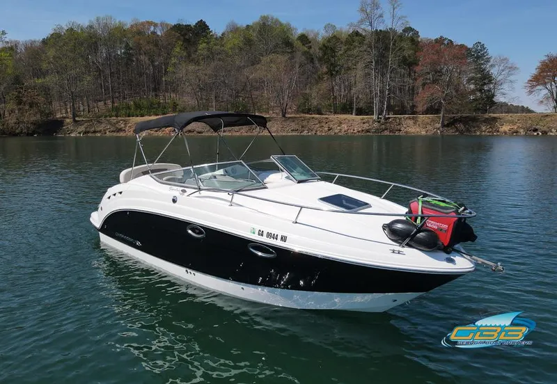 Slide: The Image of 2008 Chaparral Signature 250 boat on a serene lake with forested shoreline. - 13