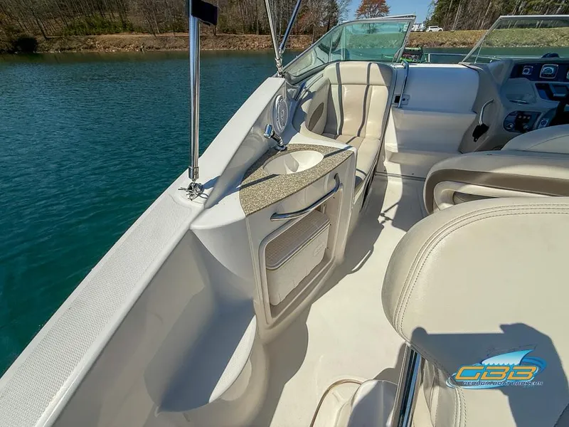 Slide: The Image of 2008 Chaparral Signature 250 boat interior with seating and helm, on a calm lake. - 18