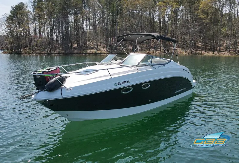 Slide: The Image of 2008 Chaparral Signature 250 boat on a serene lake with forested background. - 2