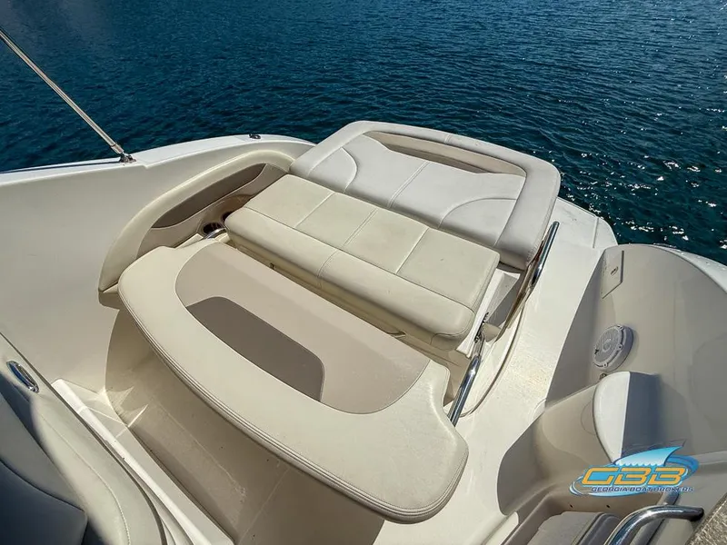 Slide: The Image of 2008 Chaparral Signature 250 boat interior with white seating, on calm blue water. - 20