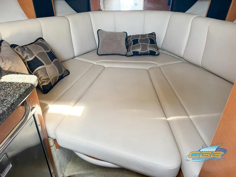Slide: The Image of 2008 Chaparral Signature 250 interior with white leather seating and decorative pillows. - 29
