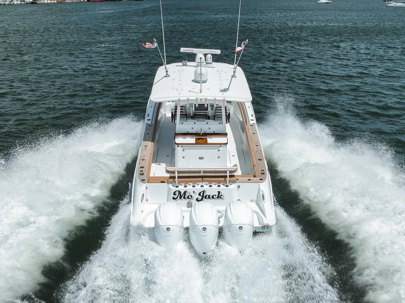 Slide: The Image of 2022 HCB Lujo boat cruising on water, rear view with powerful engines. - 13